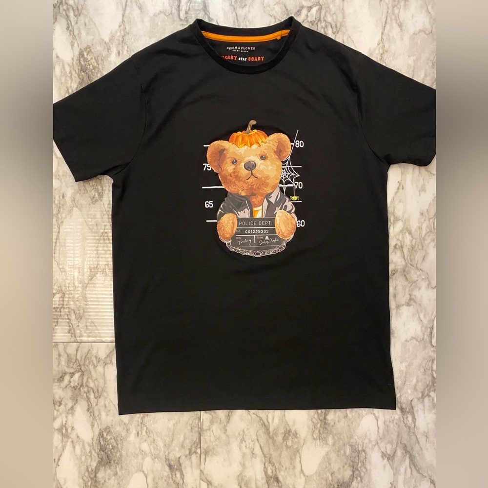 Black t-shirt by Denim and Flower with a pumpkin on his head bear